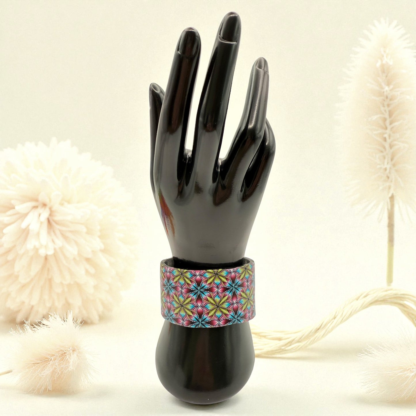 These Pretty Thiings Millefiori Cuff on a black hand and wrist display with a 1920's themed background