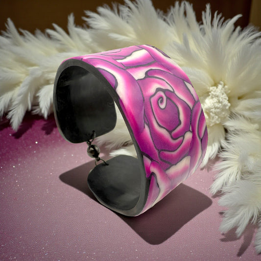 These Pretty Things Cherry Rose Cuff on a pink base with a cream feather boa in the background