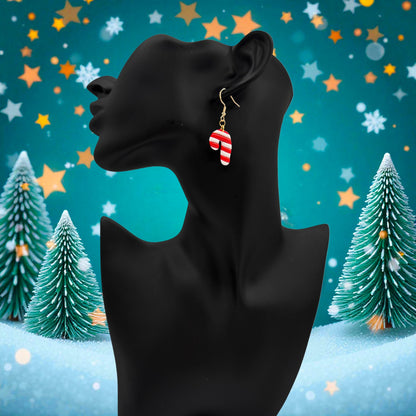 Black mannequin head with Christmas Candy Cane earrings against a festive background with trees and stars.