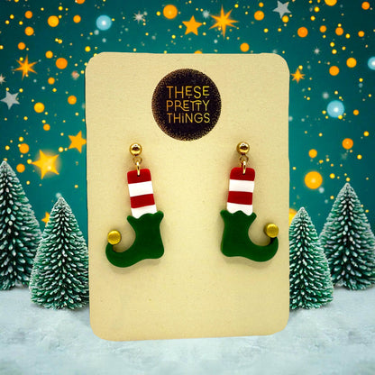 Elf Boots & Socis earrings on a 'These Pretty Things' presentation card with a festive background including snow, Christmas trees and stars.