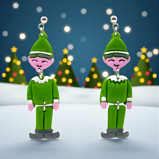 Elf earrings with a festive background of Christmas trees and lights.