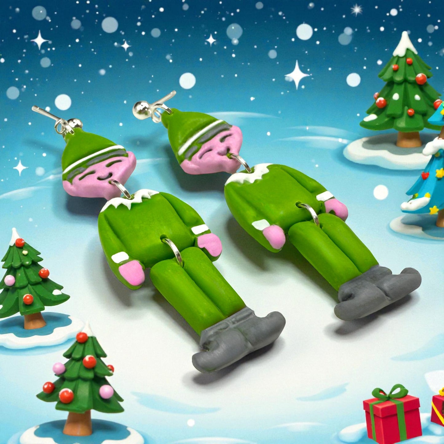 A pair of Christmas Elf earrings on a snowy background with Christmas trees and presents.