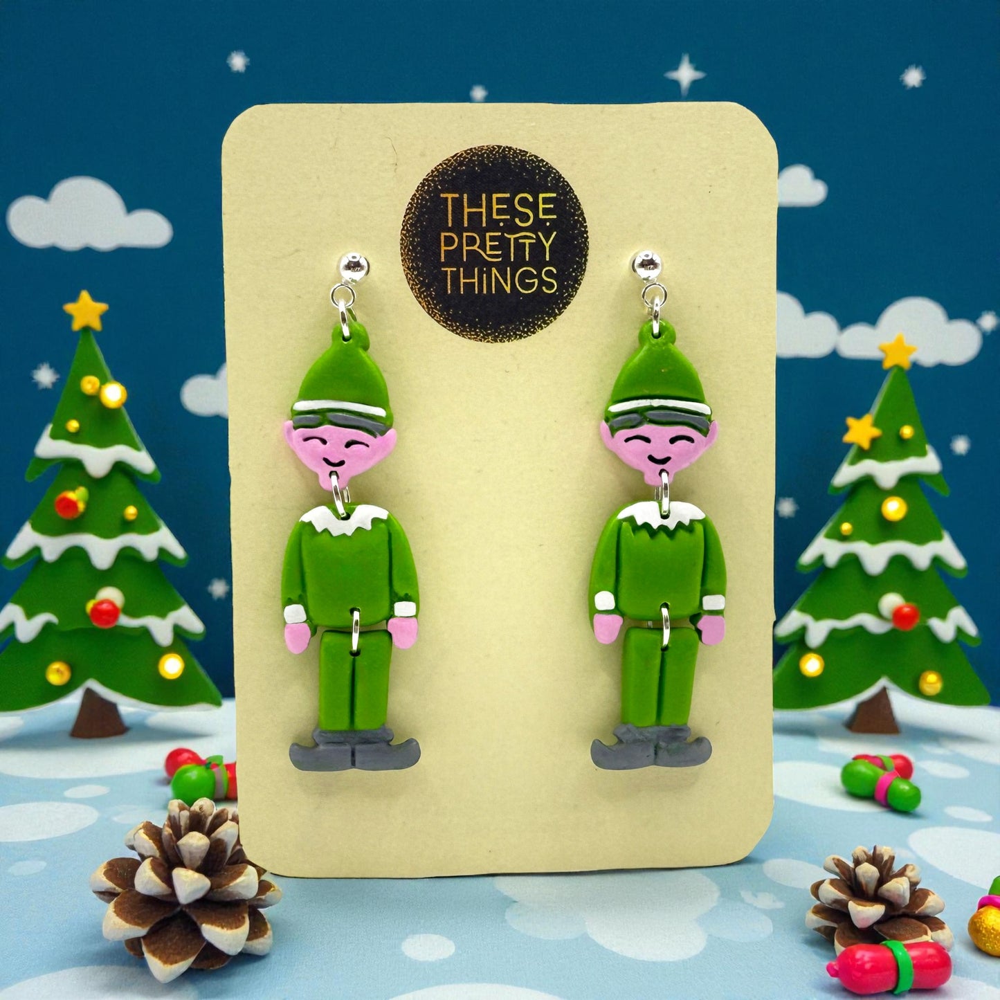 Elf earrings on a 'These Pretty Things' presentation card with Christmas-themed background