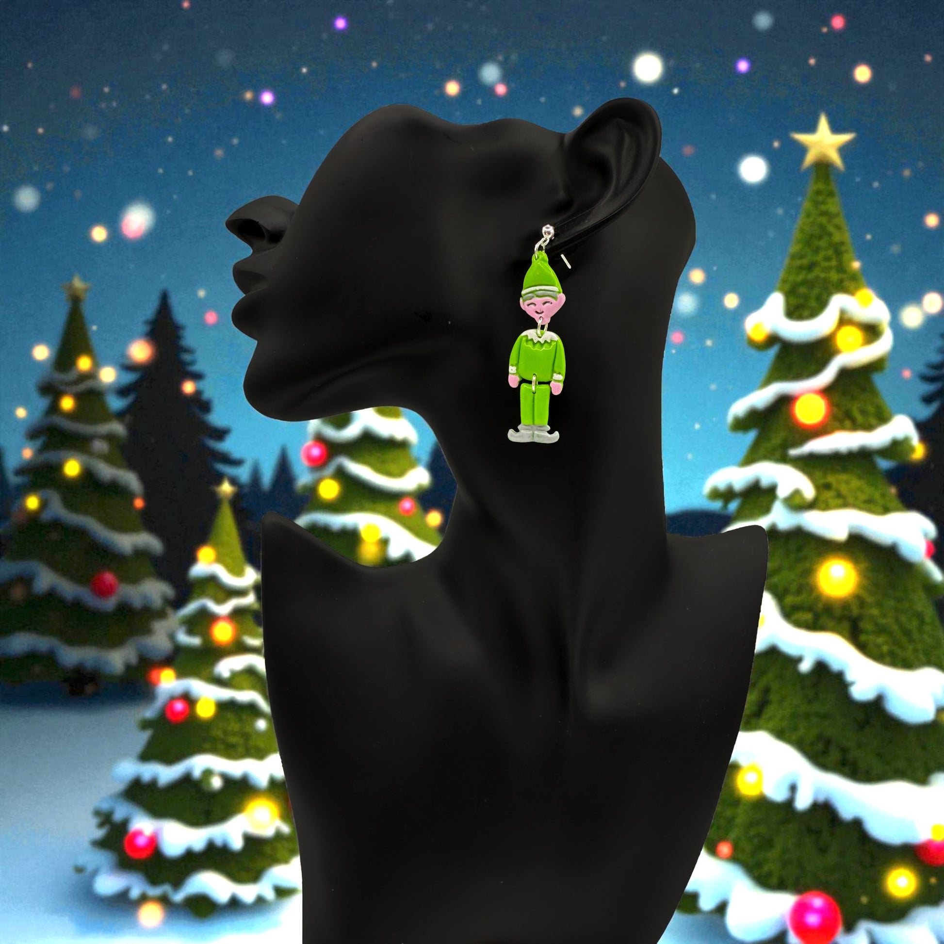Elf earring on a black mannequin against a festive Christmas tree background.