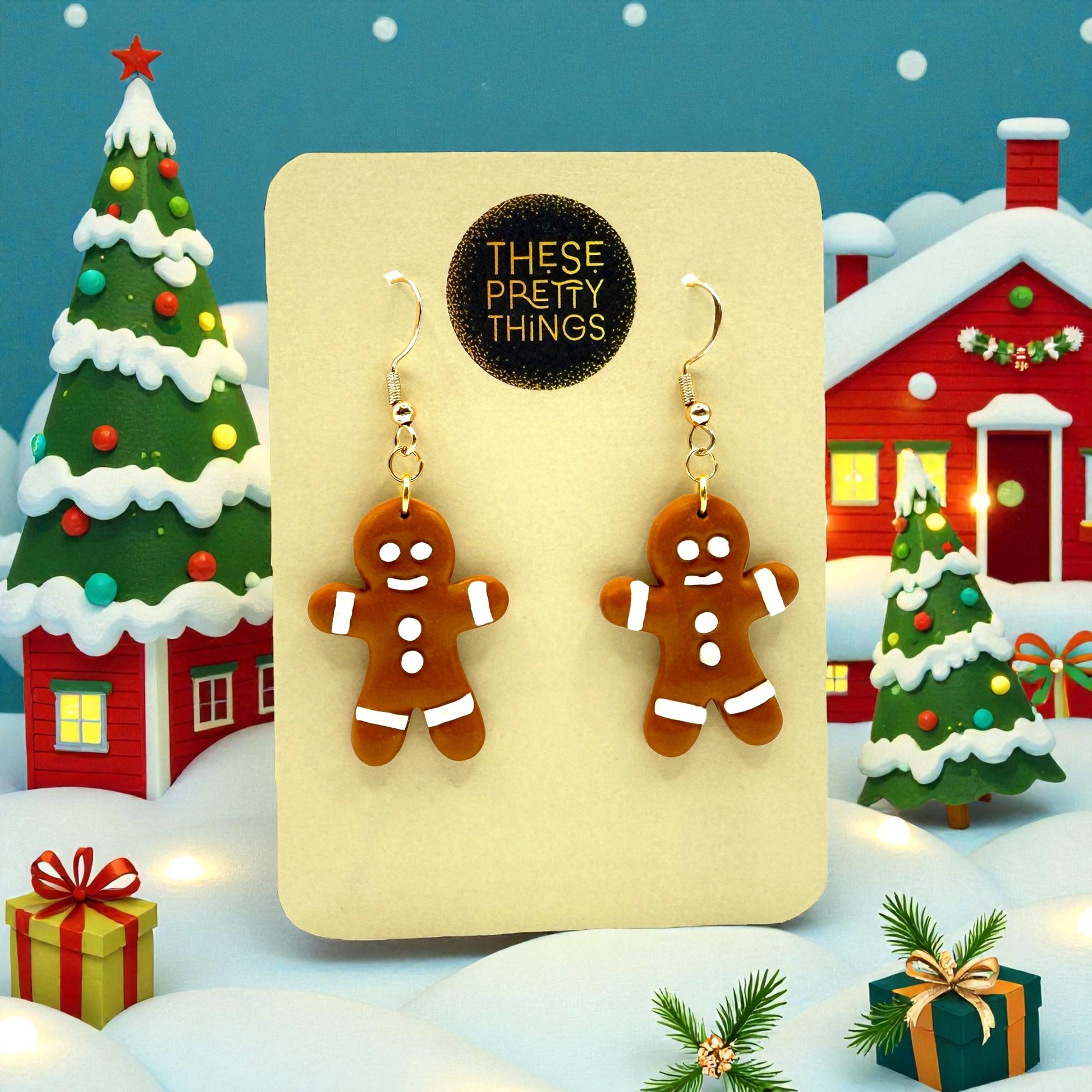 Gingerbread men earrings on a 'These Pretty Things' presentation card with a Christmas-themed background.