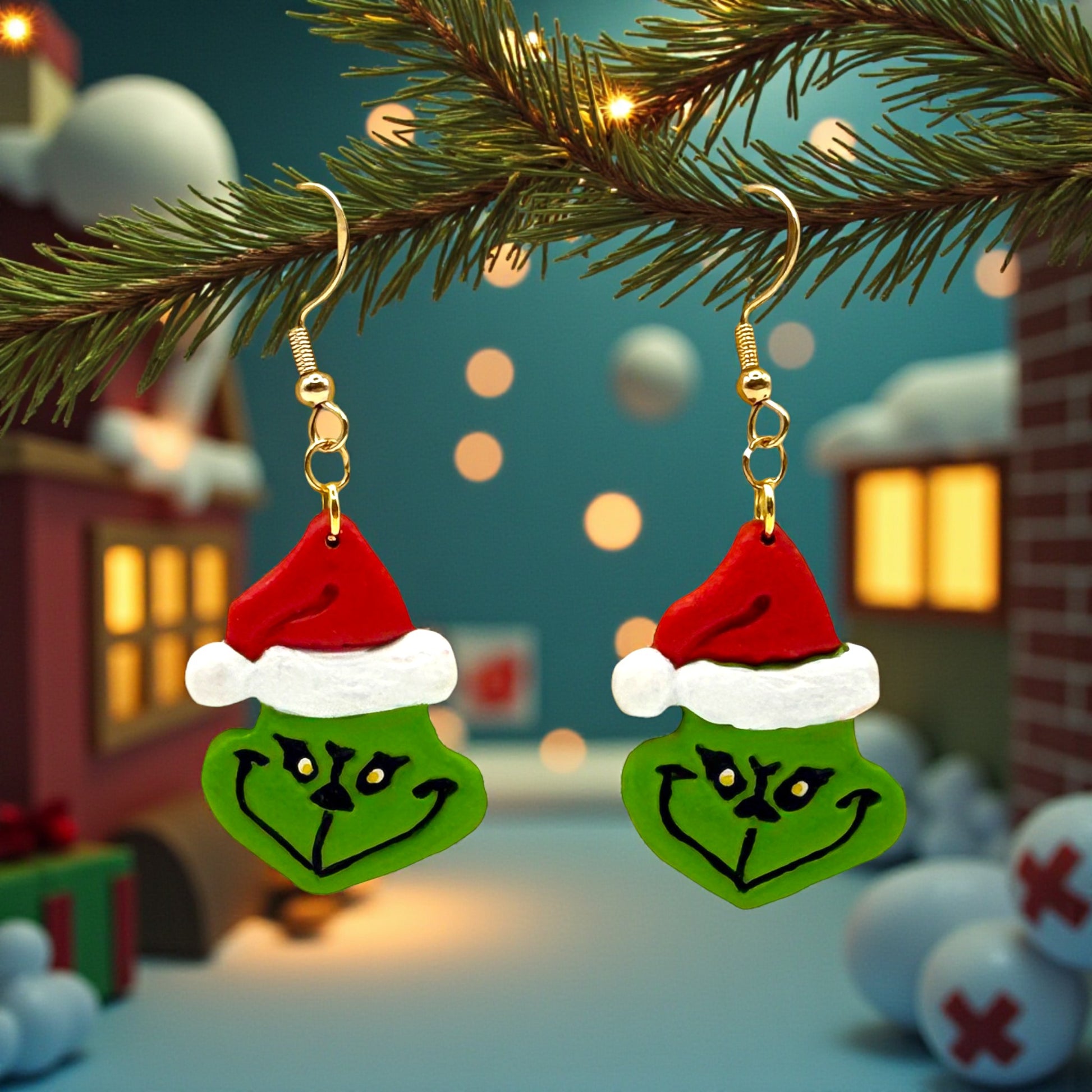 Grinch face earrings hanging from a Christmas tree branch with festive background.