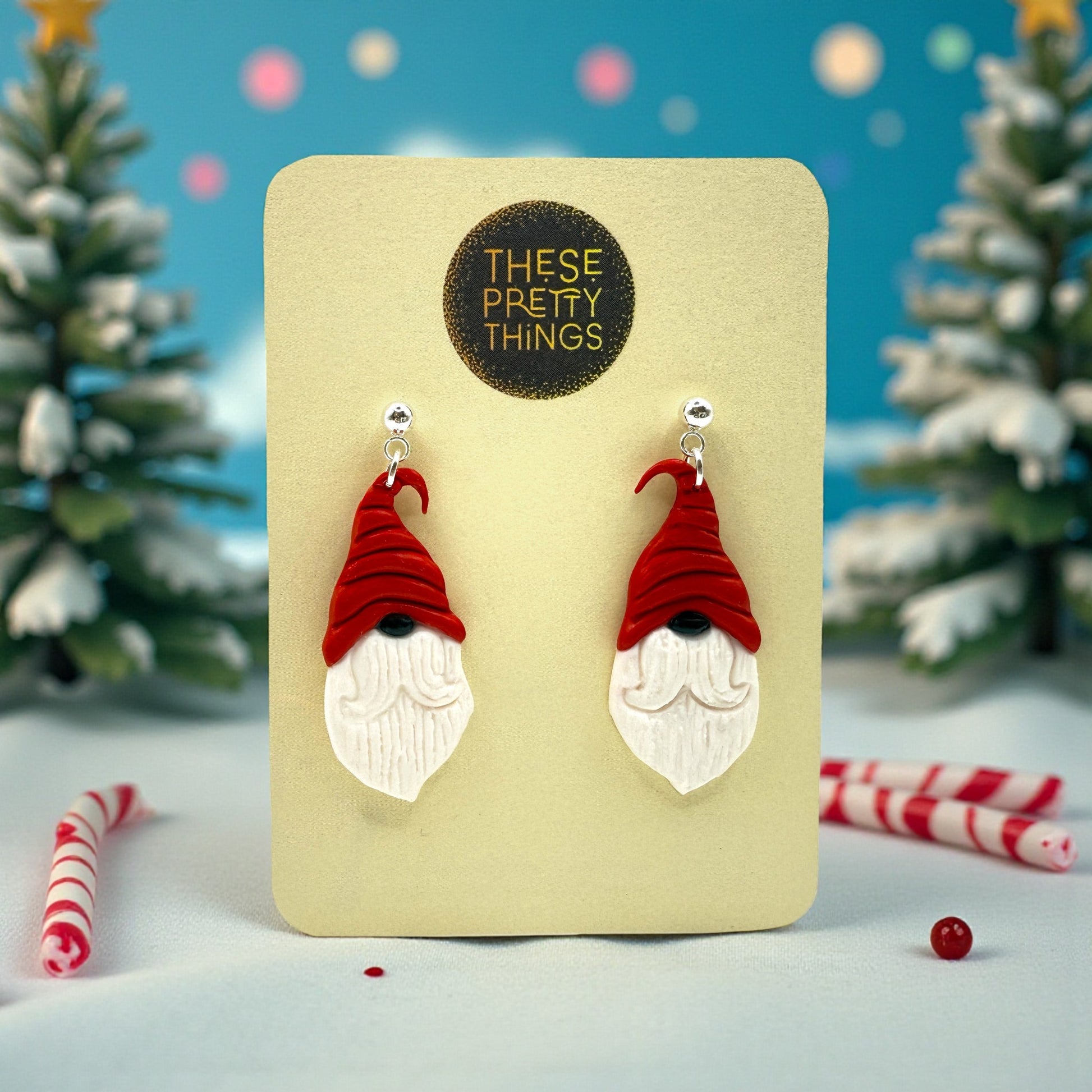 Nordic Santa earrings on a 'These Pretty Things' presentation card with Christmas-themed background
