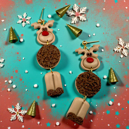 Reindeer earrings on a colorful background with snowflakes and Christmas trees.