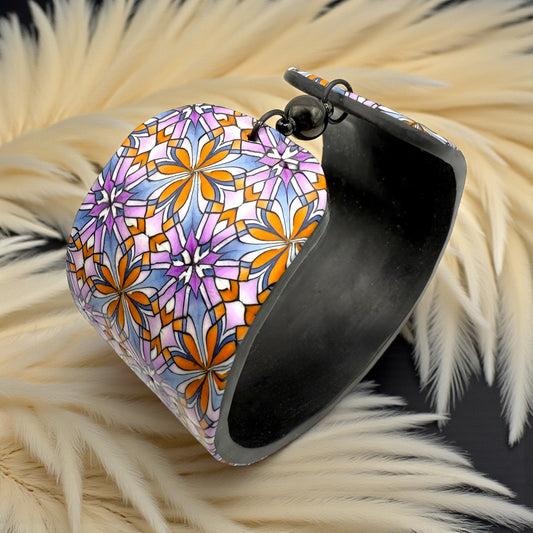 These Pretty Things Floral Geometric Cuff with a 1920's themed background including a beige feather boa.