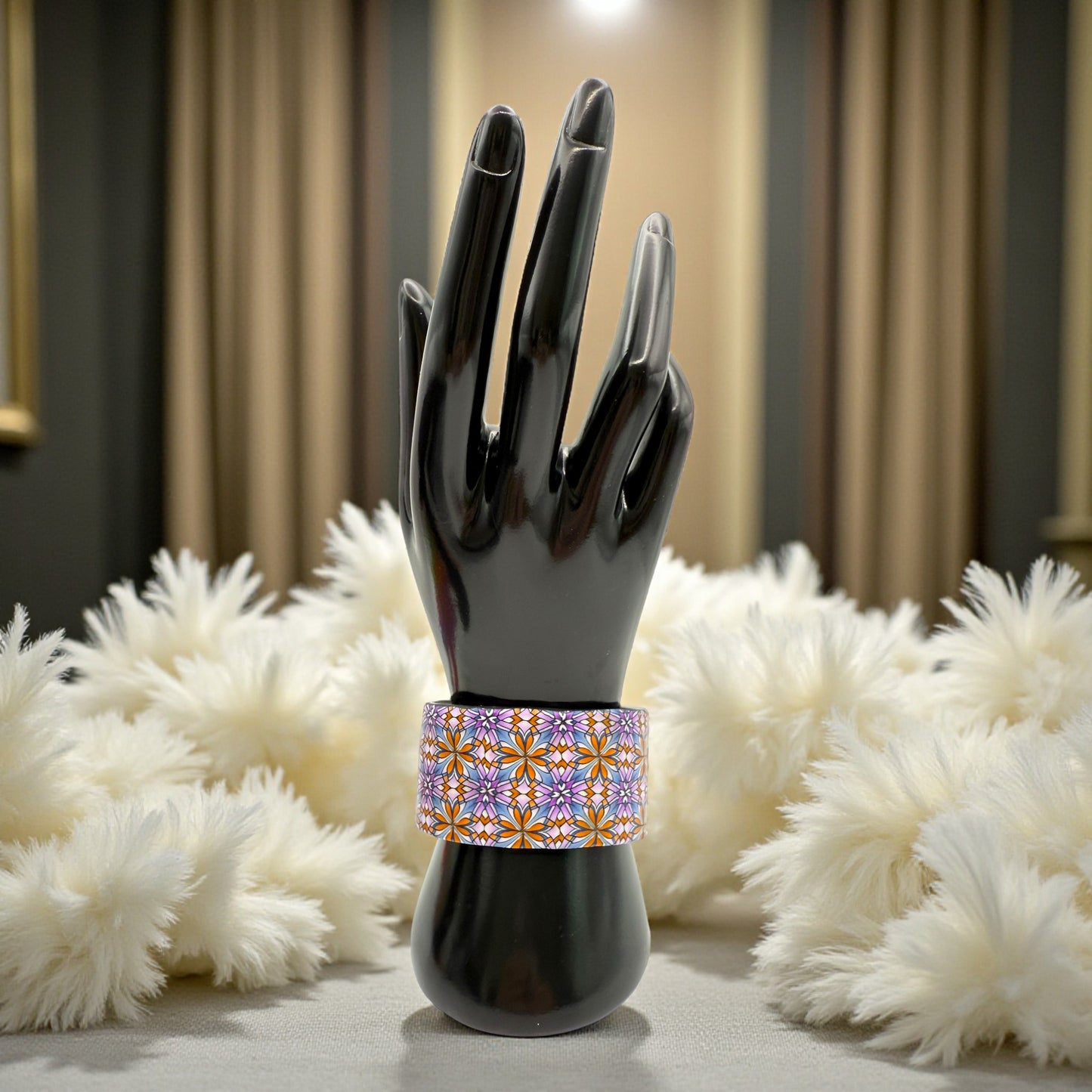 These Pretty Things Floral Geometric Cuff with a 1920's themed background including a beige feather boa.