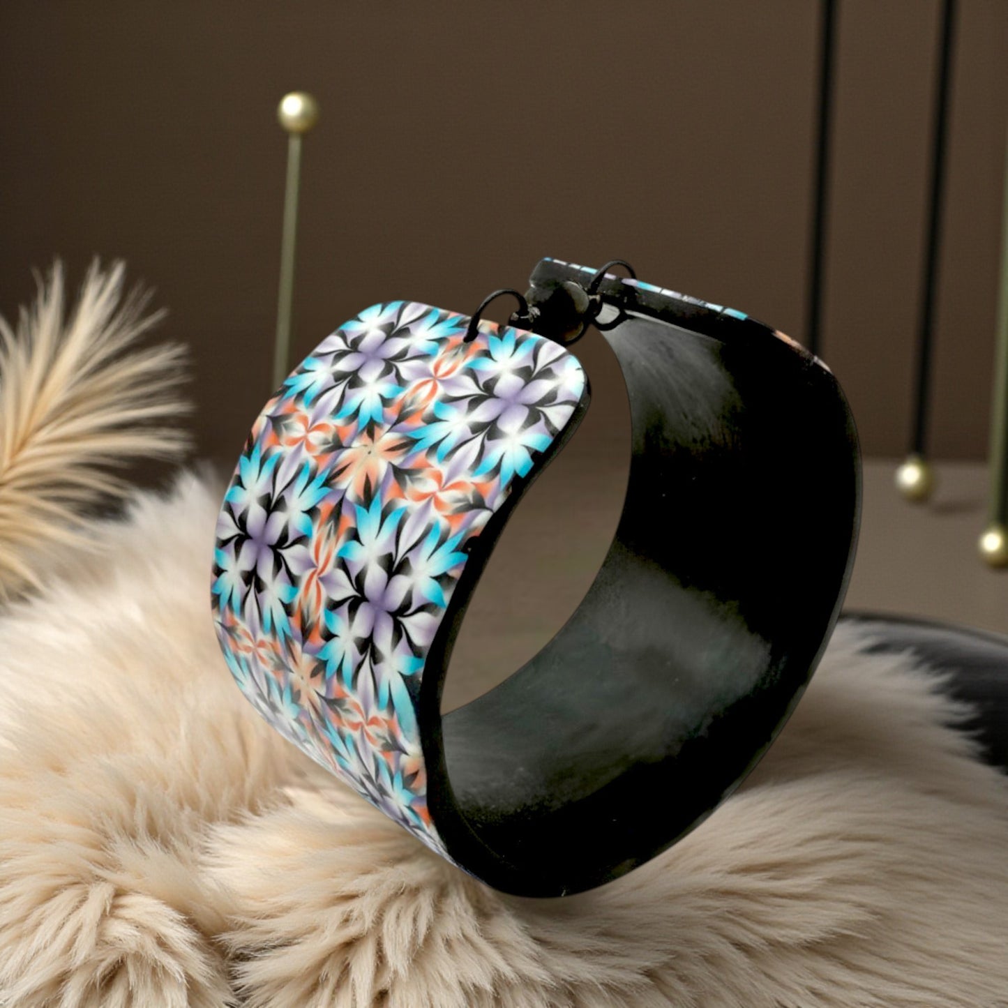 These Pretty Things Kaleidoscope Multicoloured Cuff with a 1920's inspired background using a cream feather boa.