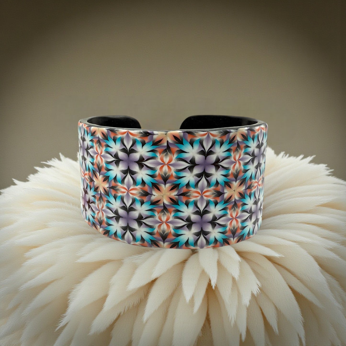 These Pretty Things Kaleidoscope Multicoloured Cuff with a 1920's inspired background using a cream feather boa.