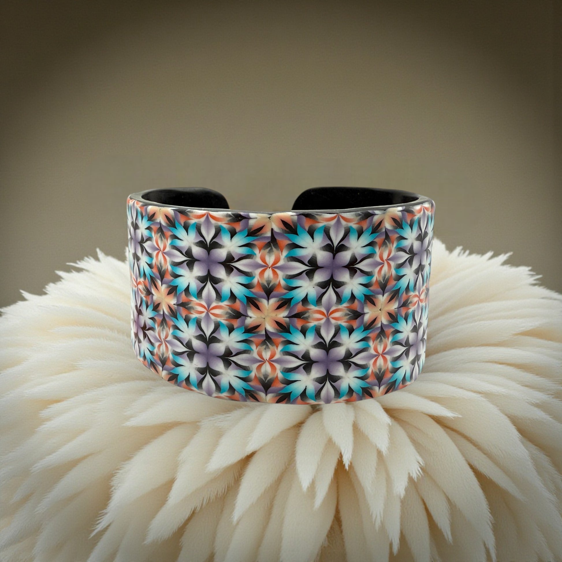 These Pretty Things Kaleidoscope Multicoloured Cuff with a 1920's inspired background using a cream feather boa.