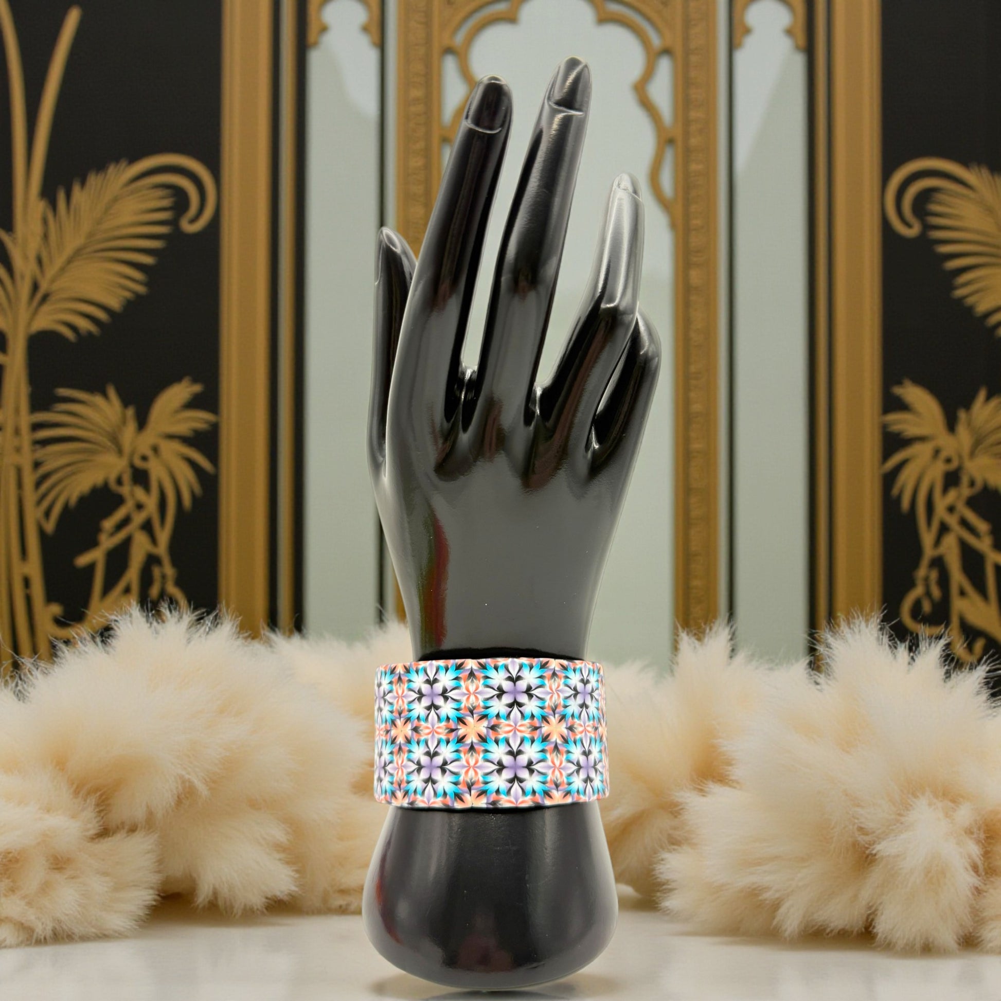 These Pretty Things Kaleidoscope Multicoloured Cuff with a 1920's inspired background using a cream feather boa.