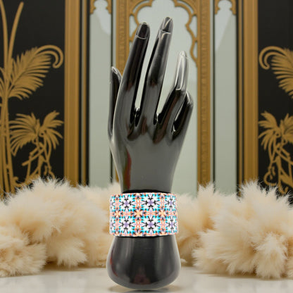 These Pretty Things Kaleidoscope Multicoloured Cuff with a 1920's inspired background using a cream feather boa.