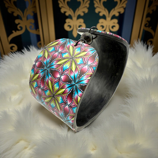 These Pretty Thiings Millefiori Cuff nestled on a beige feather boa with a 1920's themed background