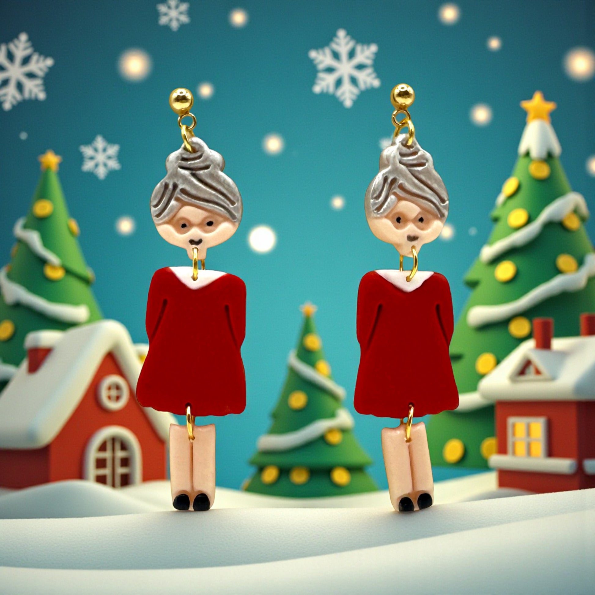 Festive Mrs Christmas in a red dress with silver hair earrings with a Christmas village background featuring snow covered chalets and Christmas trees