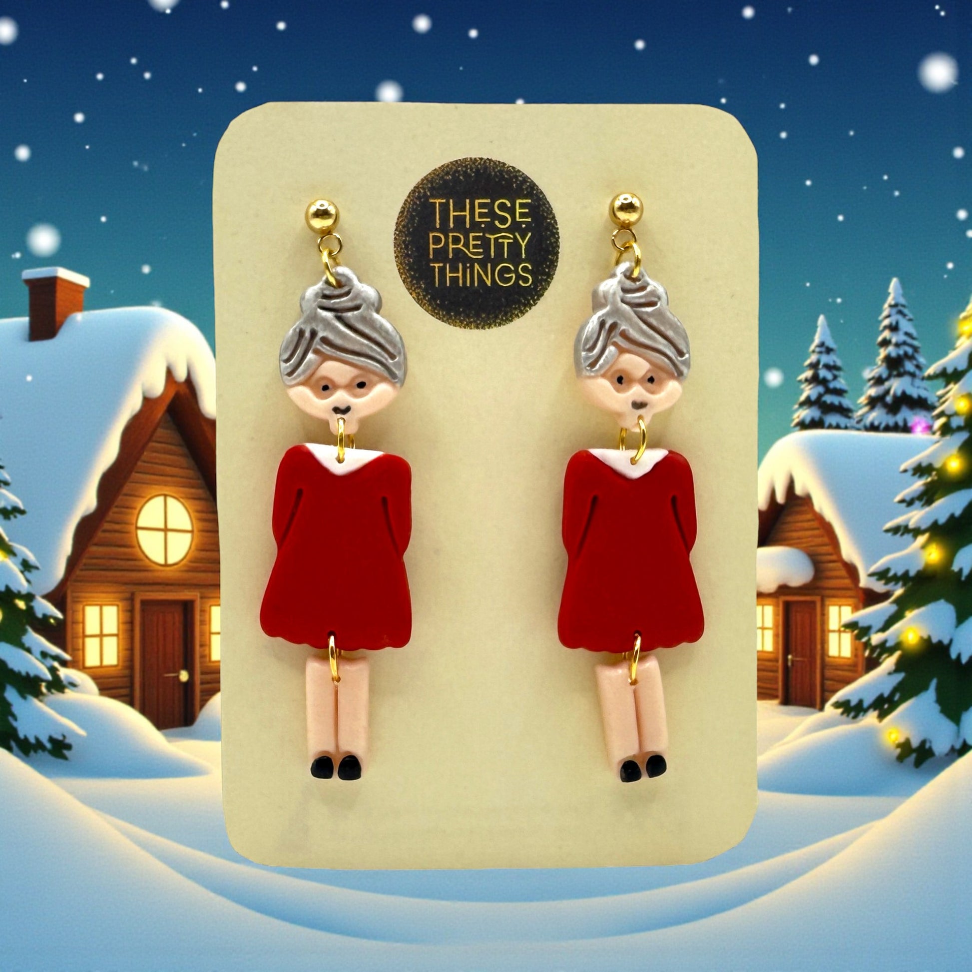 Festive Mrs Christmas earrings on a These Pretty Things presentation card with a snowy themed background