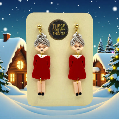 Festive Mrs Christmas earrings on a These Pretty Things presentation card with a snowy themed background