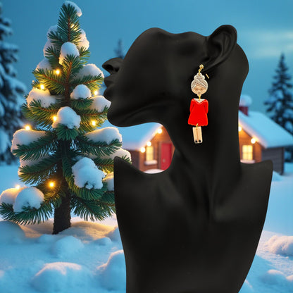 Festive Mrs Christmas earrings on a black mannequin with a snowy Christmas tree in the background
