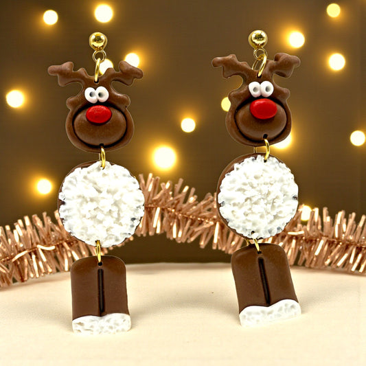 Dark brown Reindeer earrings with a white fur-like tummy set in a festive background with tinsel and fairy lights